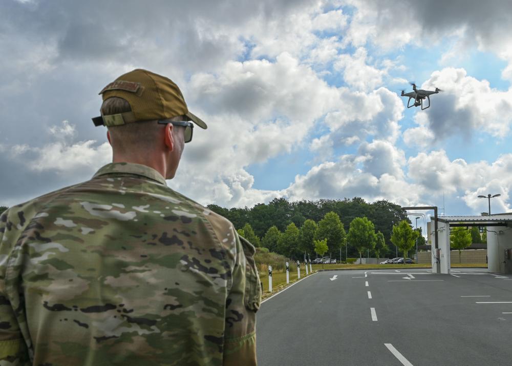 a military drone flown by a man in a camouflage uniform