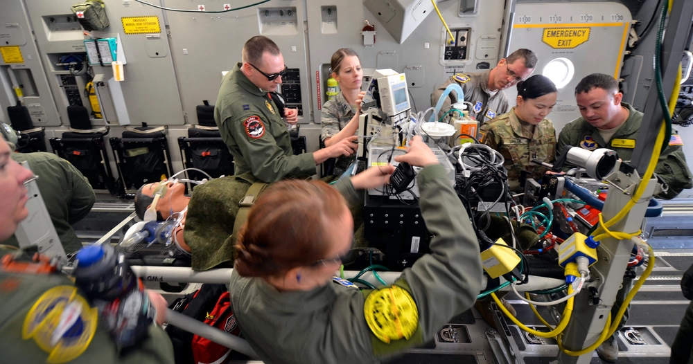 Air Force and Army medics stabilize a simulated patient connected to an extracorporeal membrane oxygenation machine (ECMO) upon boarding a C-17 Globemaster III for transport from Patrick Air Force Base, Florida, March 4, 2017 as part of the 5th annual MEDBEACH joint medical response exercise. ECMO is a treatment that uses a pump to circulate blood through an artificial lung back into the bloodstream of a patient. (U.S. Air Force photo/Tech. Sgt. Lindsey Maurice)